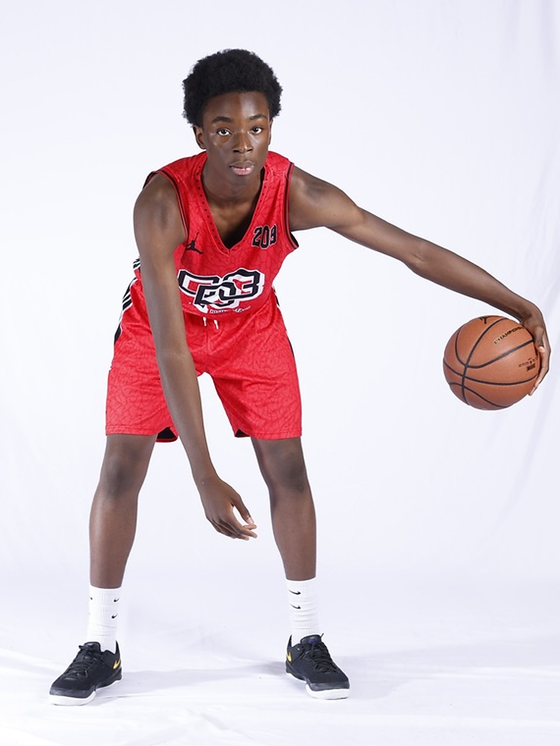 Miracle Oruchukwu in a red basketball uniform