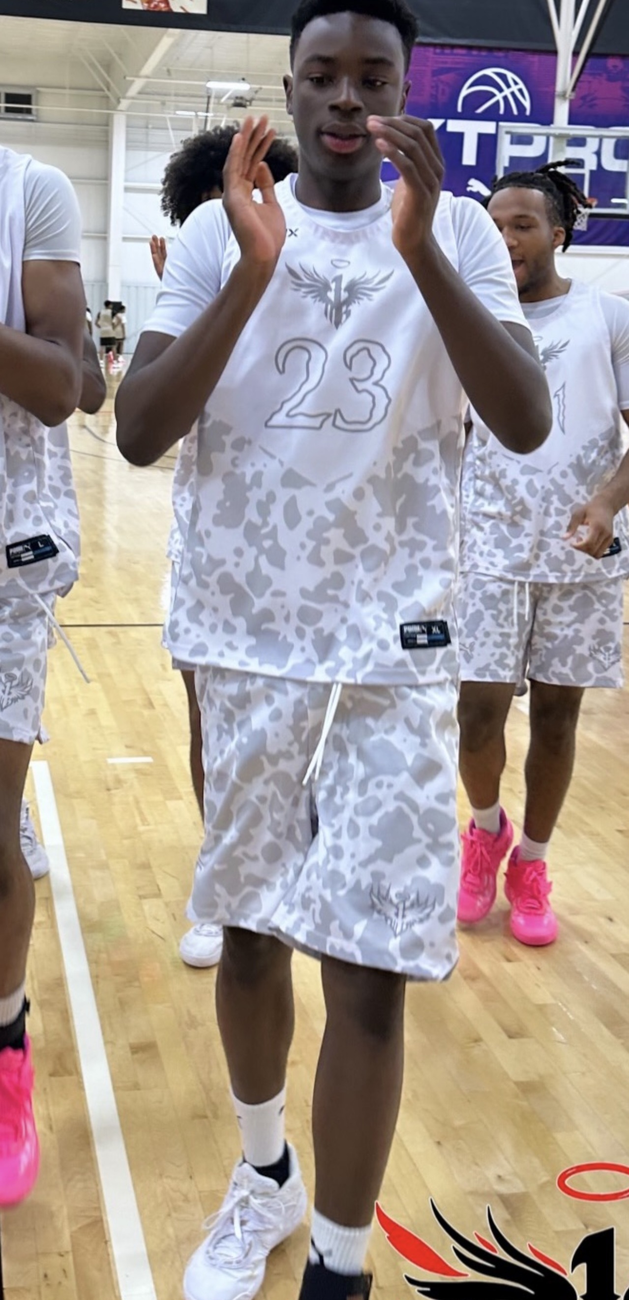 Miracle Oruchukwu with teammates in 1 of 1 Elite Canada gear